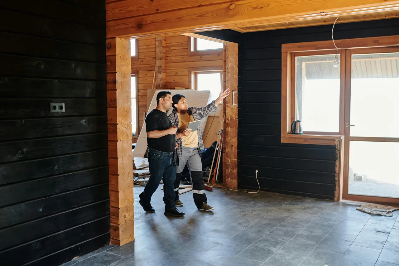 Two professionals reviewing a wood-framed interior
